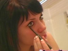 Cute teen putting on makeup